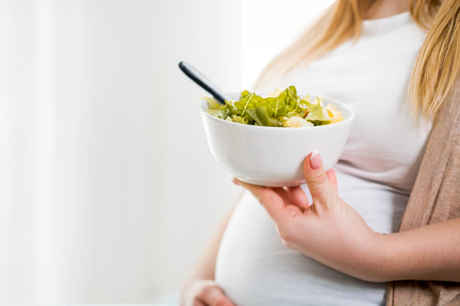 pregnant women eating salad
