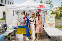 Ukrainian stand. In the foreground three young long-haired girls.