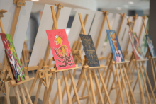 Exhibition, colorful paintings set up on wooden easels