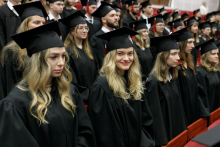 Graduation ceremony. Young girls in togas and academic birettas.