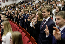 A group of young people with their right hand raised, take the oath.