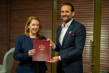 A woman and a man. Together they hold a diploma