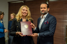 A woman and a man. Together they hold a diploma