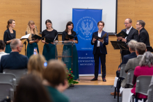 On stage, a choir - four women and three men.