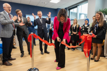The head of the Dean's Office Project Support Department cutting the ribbon. Behind her and next to her stand the other participants of the event.