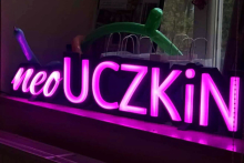 Purple neon sign with the word UCZKIN.