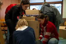 A group of people packing parcels.