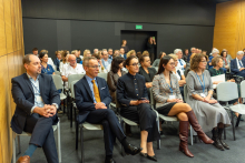 The event participants who are seated on chairs.