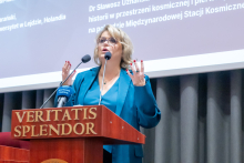 Senator Agnieszka Gorgoń-Komor stands at the podium and speaks during the conference. 