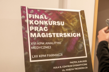 A close-up of a standing event poster with the text.