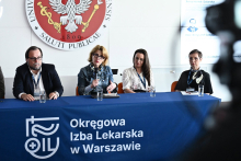 Cztery osoby siedzą przy stole panelowym. Jedna z nich - prof. Andrea Horvath-Stolarczyk zabiera głos podczas dyskusji konferencyjnej.