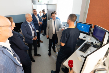 Several people take part in a presentation of a computer workstation used to operate medical equipment.
