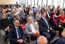 Attendees listen to presentations in a conference hall during the forum.