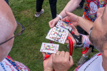 Several participants hold commemorative medals. The photograph focuses on the medals and ribbons.