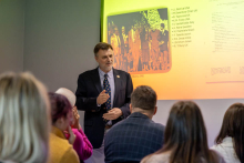 A man is giving a presentation to a group of participants.