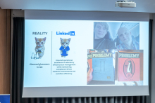 A presentation screen displays a slide comparing “REALITY” and “LinkedIn,” along with images related to laboratory work and publications.