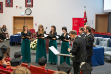 A choir performs for participants attending the inauguration ceremony in the auditorium.