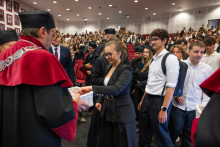 Students queue to receive materials from university representatives during the ceremony.