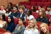 Students are seated in rows in the auditorium, attending the opening of Orientation Week 2026.