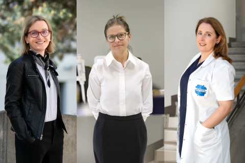 Three people dressed in professional attire: on the left, a person in a black leather jacket and a scarf; in the middle, a person wearing a white blouse and a dark skirt; on the right, a person in a white medical coat standing on the stairs.