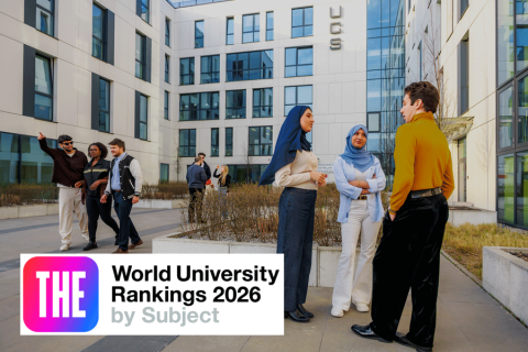 Students gathered and talking in a modern university courtyard, with a building marked ‘UCS’ in the background and a graphic displaying ‘World University Rankings 2026 by Subject’ in the foreground.
